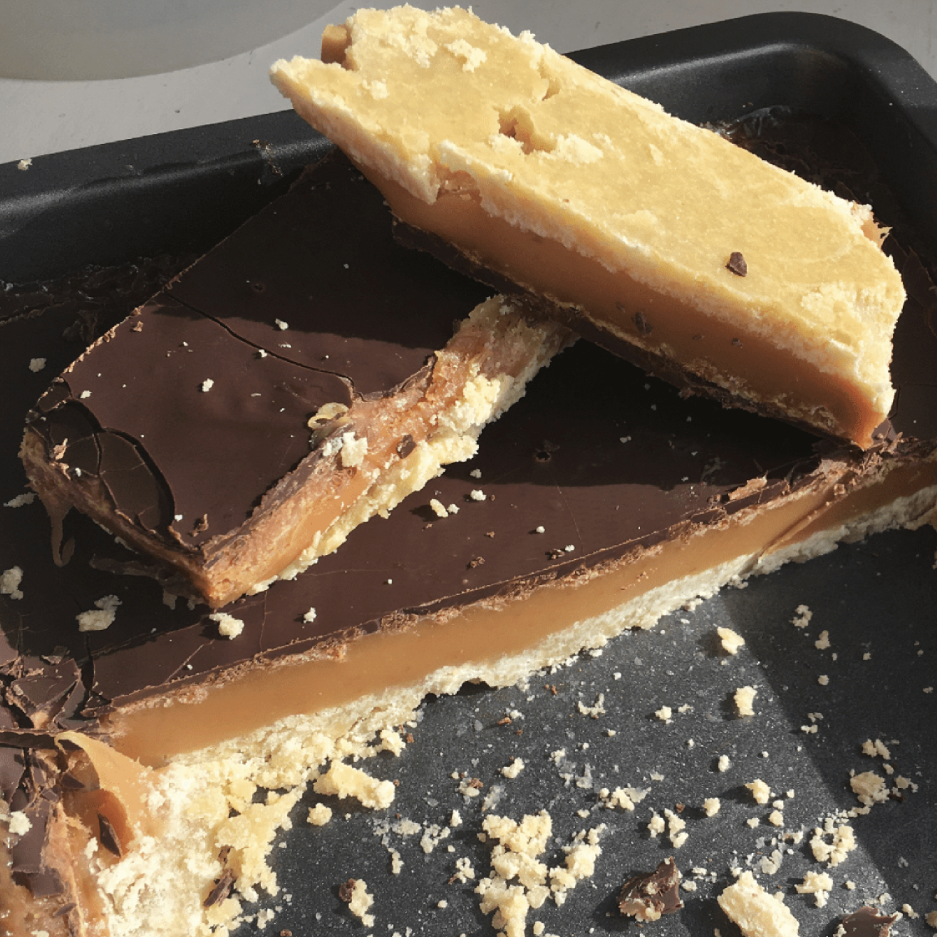 Millionaire caramel shortbread slices fresh from the baking tin